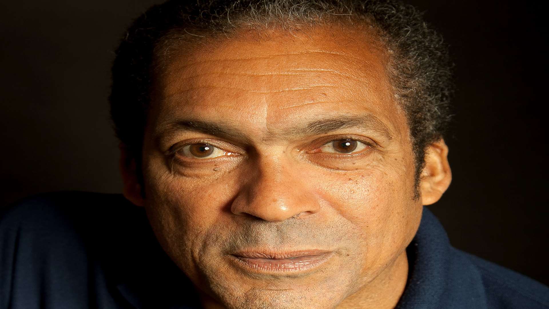 Ben Onwukwe in a dark blue t-shirt.